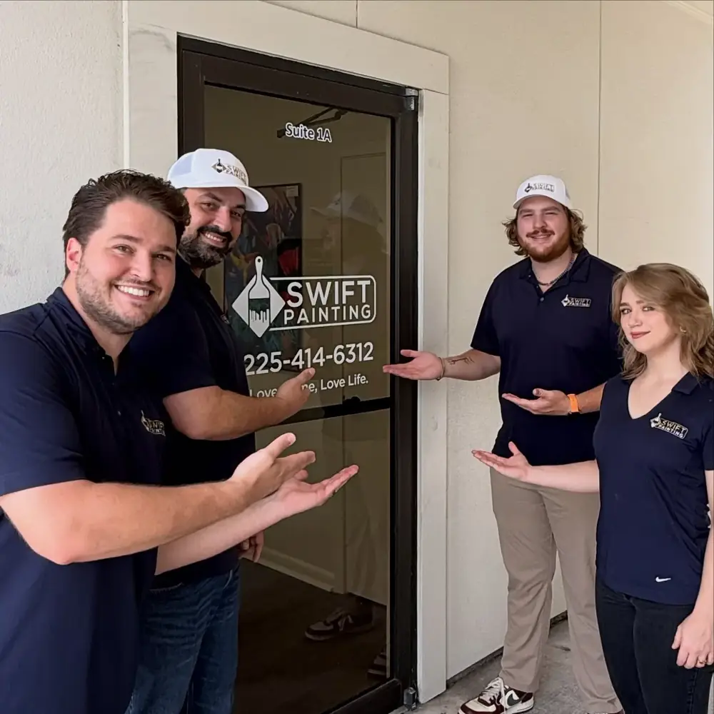 The Swift Painting team at the office door in Baton Rouge
