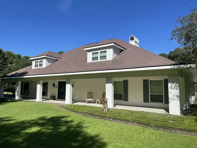 Brick ranch painted white, dark shutters
