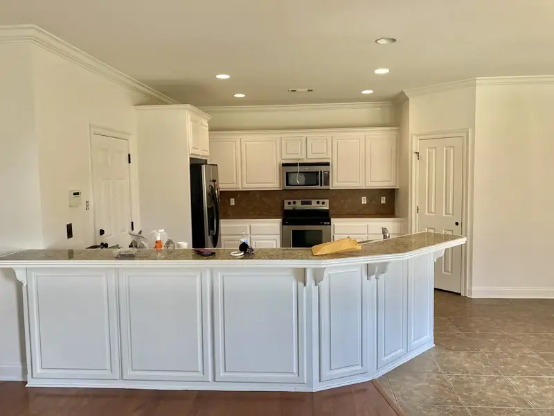 White kitchen cabinets and peninsula