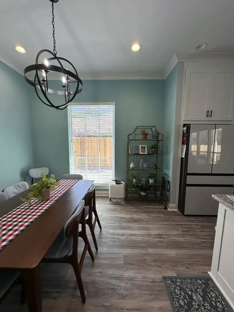 Teal accent wall in a dining area