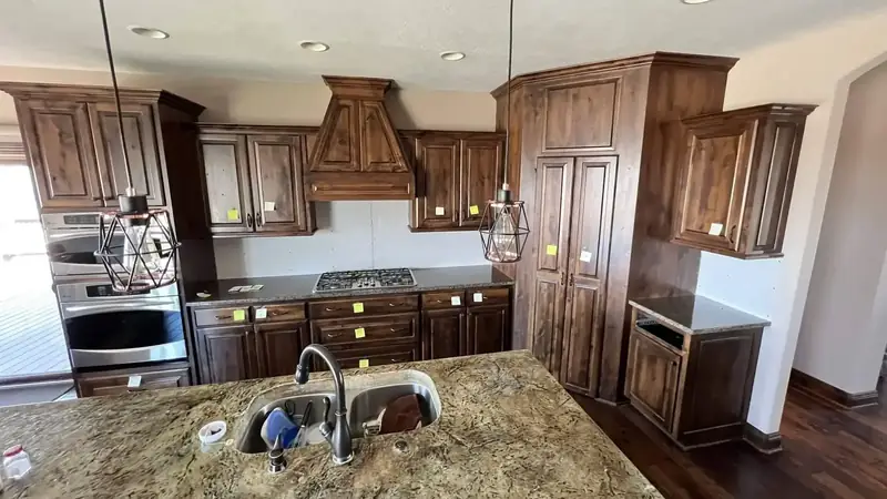 Kitchen before: stained wood cabinets