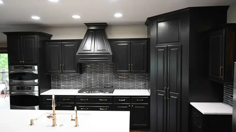 Kitchen after: black cabinets, white counters
